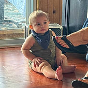 Elias joined the competition — help win amazing prizes! baby, child, indoor, floor, wooden_floor, romper, bib, footwear, sandal, toenails, window, wooden_wall, person, sitting, skin, hand, face, expression, light, home