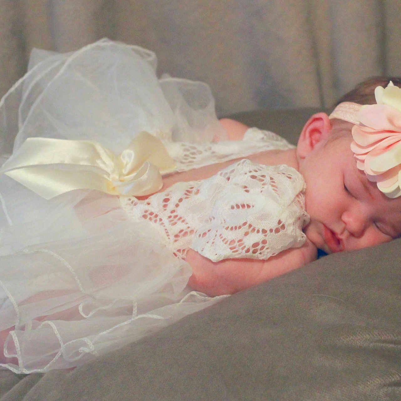 Kyleigh is registered to the contest to win money with this photo: accessories, baby, bed, bedroom, blanket, bonnet, clothing, costume, couch, crib, cushion, dress, earring, face, fashion, flower, flowerarrangement, flowerbouquet, formalwear, furniture