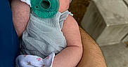Julia is registered to the contest to win money with this photo: newborn, baby, infant, sleeping, pacifier, headband, mittens, floral, onesie, portrait, closeup, face, child, caregiver, arms, outdoor, grass, stone, hands, cozy