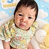 Julia is registered to the contest to win money with this photo: baby, newborn, infant, child, portrait, face, eyes_open, looking_at_camera, floral_outfit, dress, sitting, blanket, balloons, clouds, pastel, blue_background, three_weeks, indoor, cute, photography