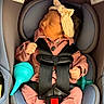 Julia joined the competition — help win amazing prizes! baby, infant, sleeping, car_seat, safety_harness, headband, bow, pink_clothing, rattle, pacifier, toy, vehicle, indoors, portrait, face, hands, feet, seated, child, nap