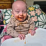 Lexi joined the competition — help win amazing prizes! baby, child, smile, messy_face, baby_food, highchair, tray, hands, onesie, pillow, floral_pattern, cushion, wooden_cabinet, indoor, furniture, feeding_time, stains, tabletop, portrait, happy
