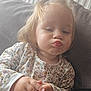 Léna participe au concours pour gagner de l'argent avec cette photo : toddler, child, pout, cute, floral_shirt, hands, couch, cushion, indoor, portrait, blonde_hair, expression, young_child, person, face, seated, cozy, home, soft_light, casual