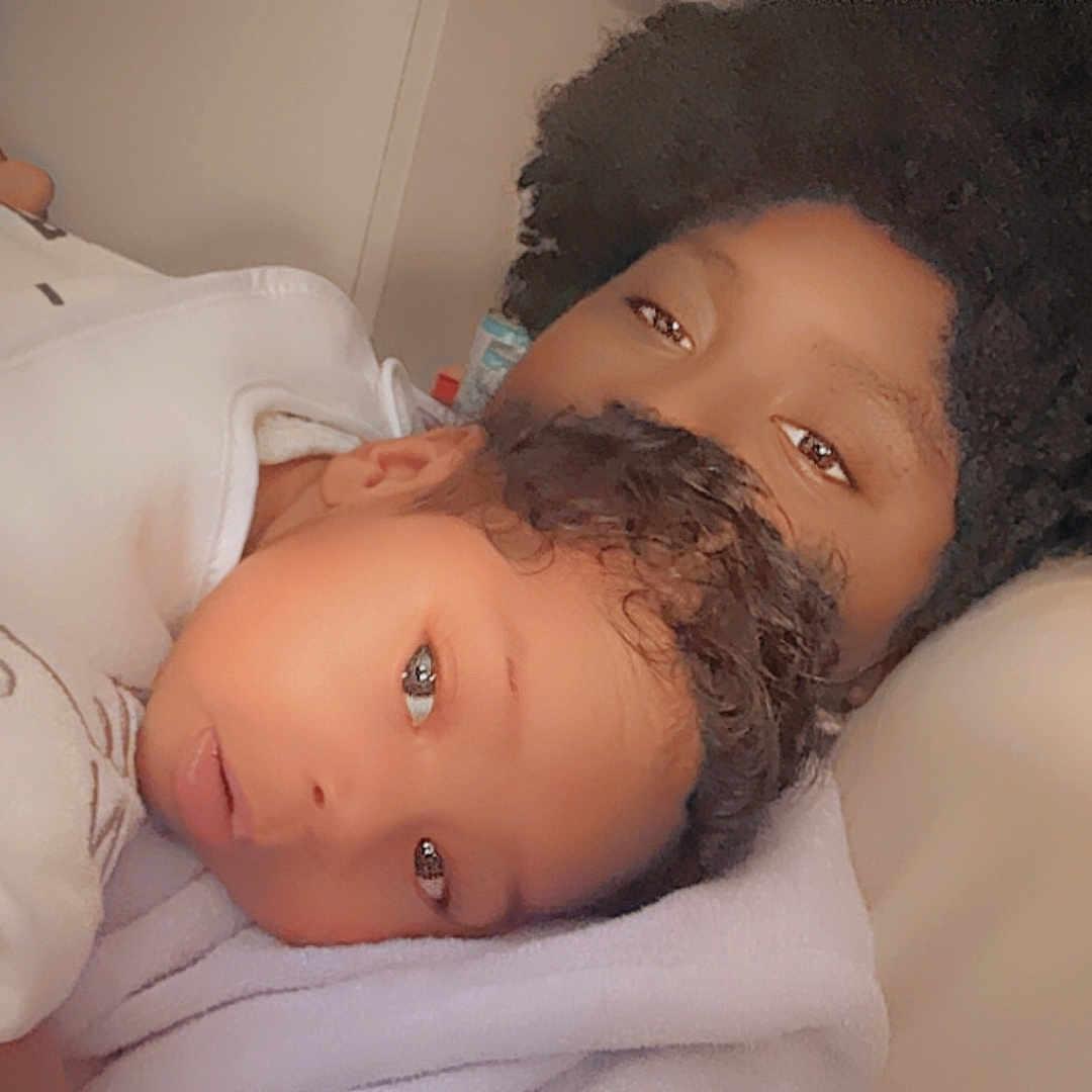 Pharaoh is registered to the contest to win money with this photo: baby, bed, bedroom, blanket, bodypart, clothing, face, finger, furniture, hand, happy, hat, head, indoors, newborn, people, person, photography, portrait, smile