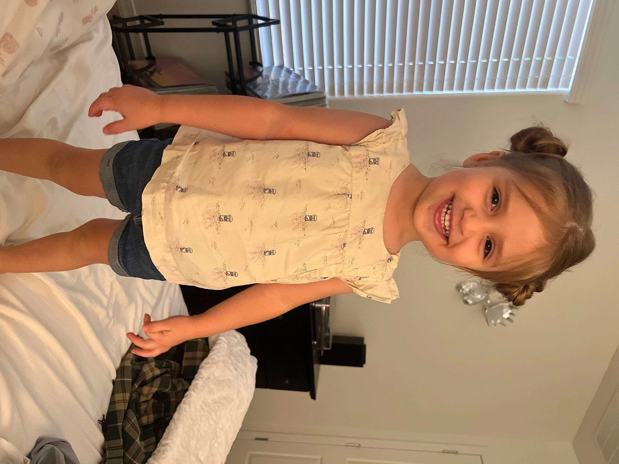 Elle is registered to the contest to win money with this photo: abdomen, baby, baby_toddler_clothing, child, comfort, elbow, fun, gesture, human_leg, joint, joy, knee, person, room, sleeve, smile, thigh, thumb, toddler, trunk