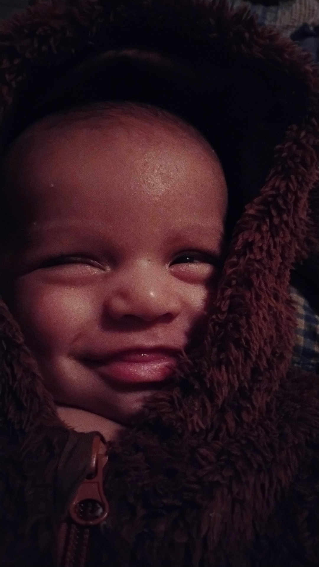 Adrian is registered to the contest to win money with this photo: baby, child, face, smile, jacket, zipper, brown, warm, closeup, happy, infant, cute, portrait, fuzzy, cozy, young, person, apparel, expression, indoors