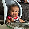 Kamari is registered to the contest to win money with this photo: baby, high_chair, pout, expression, face, infant, child, straps, seat, blanket, teddy_bear, indoor, furniture, couch, clothing, red_shirt, cute, funny, portrait, person