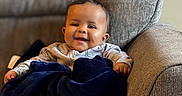Kamari joined the competition — help win amazing prizes! baby, smile, child, pajamas, blanket, armchair, cozy, happy, indoor, infant, cute, portrait, furniture, sitting, soft, warm, comfort, person, young, relaxation