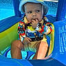 baby, child, swimsuit, hat, pool, inflatable, water, summer, outdoor, sunny, colorful, floating, toddler, cute, swimming_pool, vacation, playful, sitting, sunhat, person