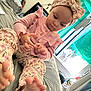 toddler, child, pink_clothing, headband, barefoot, bed, indoor, curtains, furniture, person, foot, hand, focused, casual, cozy_room, window, toes, patterned_pants, baby, home