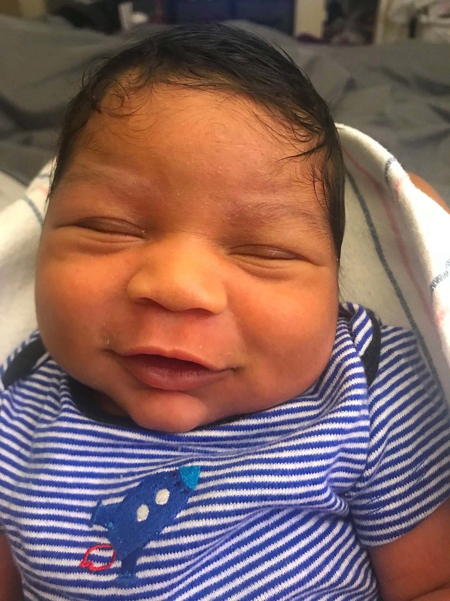 Jonas is registered to the contest to win money with this photo: baby, black_hair, cheek, child, chin, ear, eye, eyebrow, face, facial_expression, forehead, head, lip, mouth, neck, nose, person, skin, sleep, smile