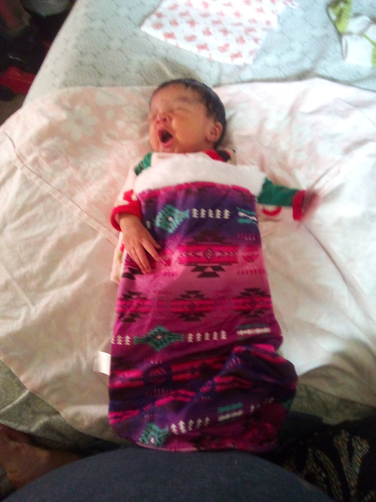 Callie is registered to the contest to win money with this photo: baby, baby_toddler_clothing, bed, bed_sheet, bedding, child, comfort, happy, linens, magenta, pattern, person, pillow, pink, room, sitting, sleeve, t_shirt, textile, throw_pillow