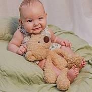 Skylar is registered to the contest to win money with this photo: baby, teddy_bear, smile, cute, infant, plush_toy, blanket, soft_lighting, indoors, child, happy, person, cuddly, sitting, face, small_feet, clothing, cozy, portrait, playful
