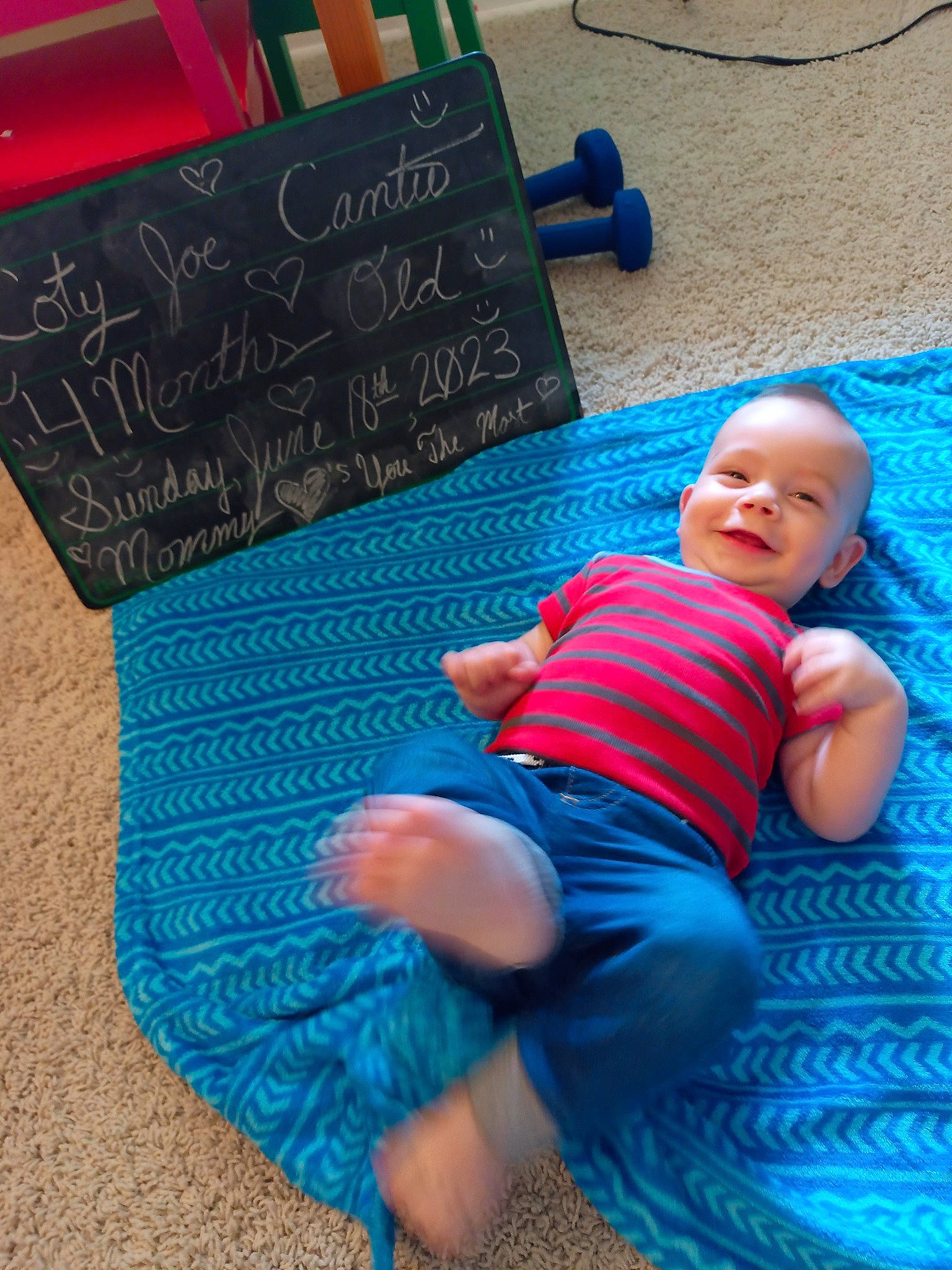 Coty is registered to the contest to win money with this photo: baby, baby_toddler_clothing, blue, chalk, cool, electric_blue, finger, flooring, grass, hand, handwriting, happy, human_body, joint, joy, knee, leg, leisure, person, t_shirt