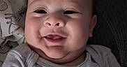 Alexander joined the competition — help win amazing prizes! baby, smiling, face, chubby_cheeks, onesie, giraffe, gray_clothing, lying_down, close_up, infant, cute, happy, child, person, soft_toys, blanket, patterned_cloth, indoors, portrait, head