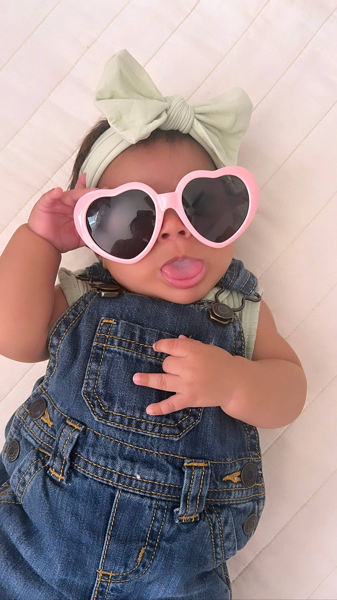 Galilea is registered to the contest to win money with this photo: baby_toddler_clothing, clothing, cool, eyewear, face, fashion, gesture, glasses, goggles, head, lip, outerwear, person, pink, skin, sleeve, sunglasses, t_shirt, textile, toddler