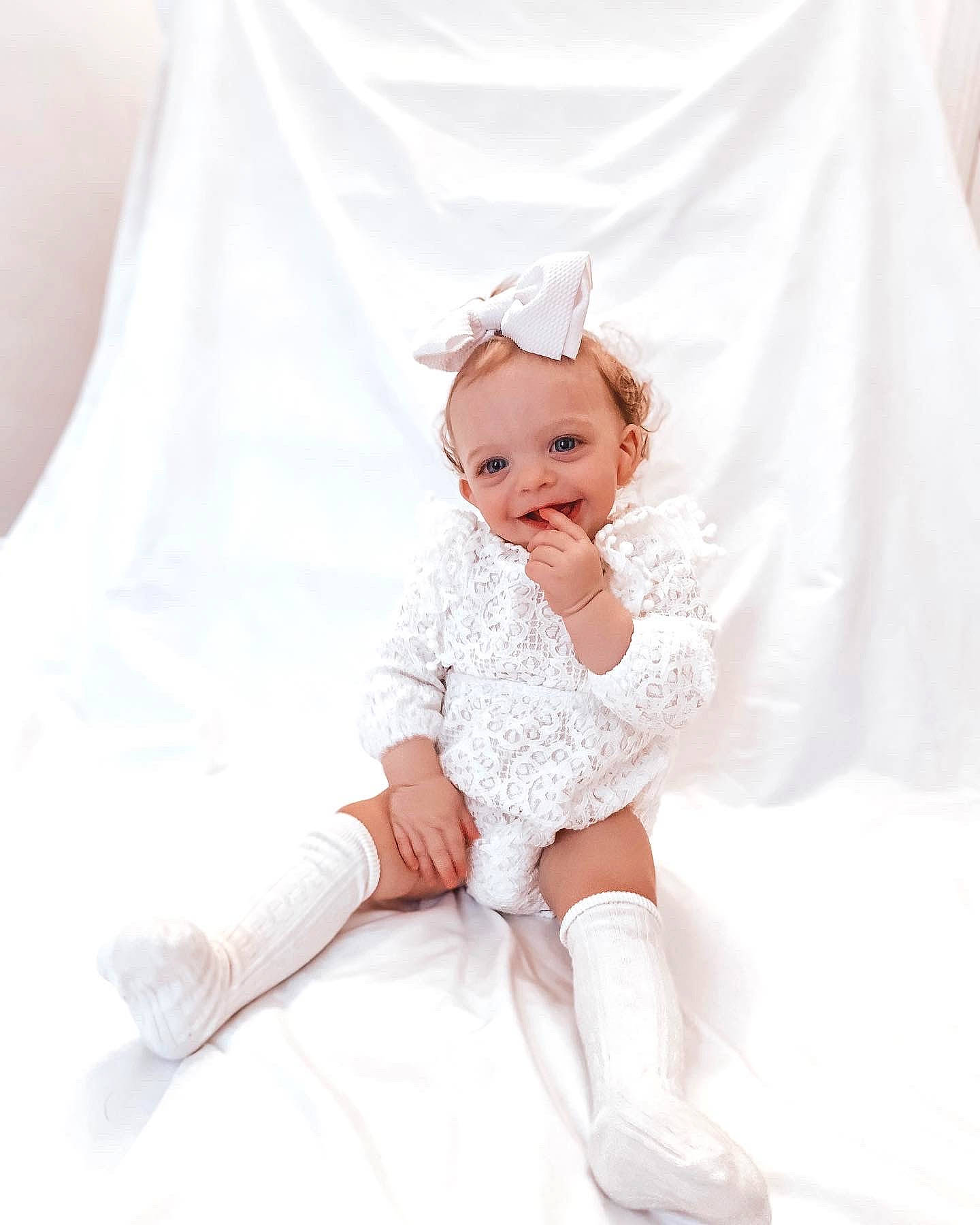 Charli is registered to the contest to win money with this photo: baby_toddler_clothing, bridal_accessory, bridal_clothing, day_dress, dress, embellishment, eyelash, fashion, flash_photography, gesture, gown, hair, happy, headgear, headpiece, human_body, joy, neck, person, sleeve
