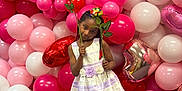 Summer is registered to the contest to win money with this photo: balloon, black_shoes, braided_hair, carpet, celebration, child, dress, flower, girl, heart_shaped_balloon, holding_flowers, indoor, pink_balloon, playful, portrait, purple_stripes, red_balloon, standing, white_dress, white_tights