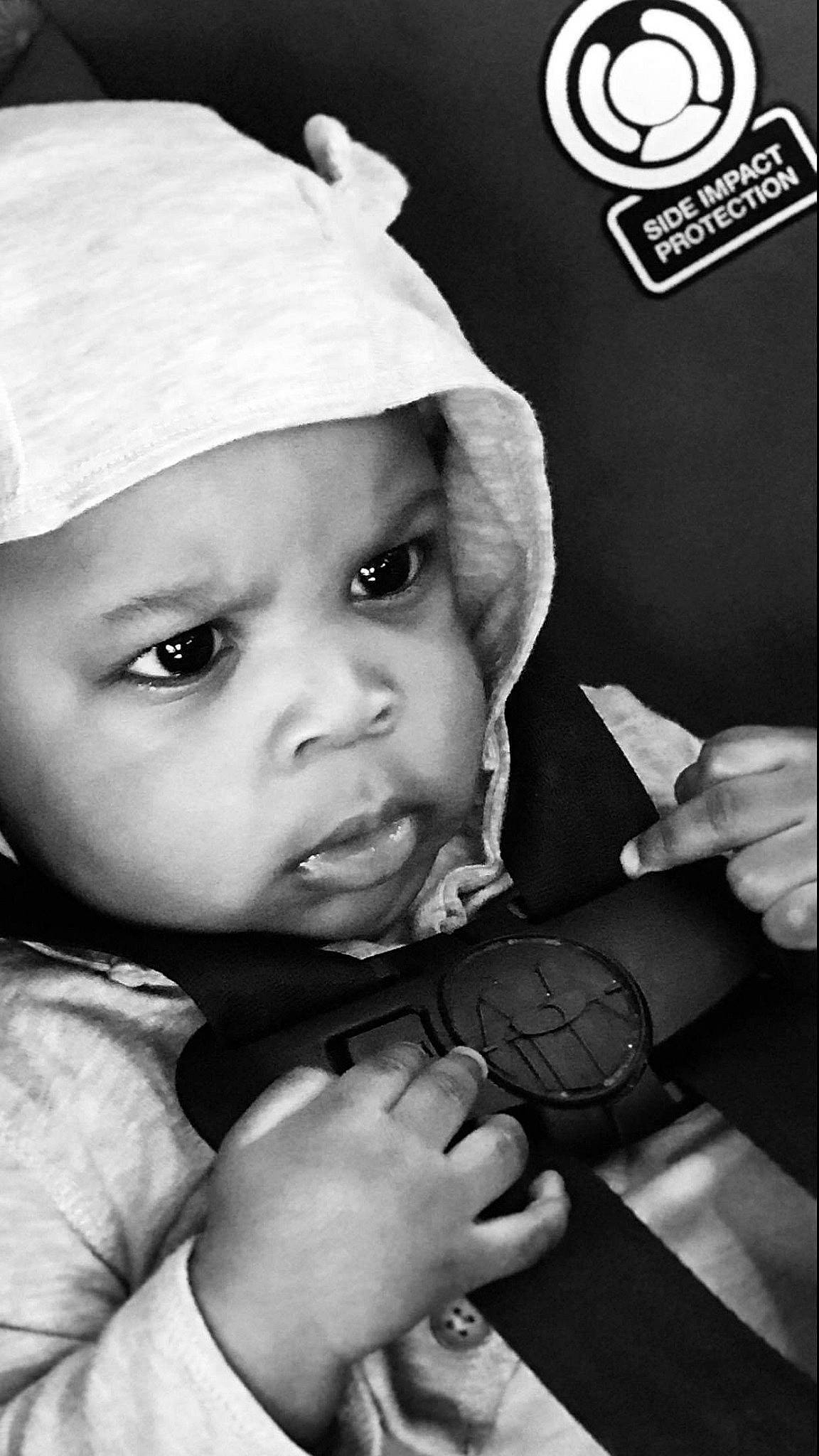 Jabari is registered to the contest to win money with this photo: baby, black, black_and_white, cap, child, hand, headgear, headwear, monochrome, monochrome_photography, person, photograph, photography, portrait_photography, style, toddler, white