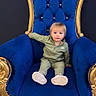 Kasen joined the competition — help win amazing prizes! toddler, child, blue_chair, gold_trim, chair, indoor, person, clothing, footwear, sitting, portrait, furniture, couch, floor, cute, young_child, expression, decor, luxury, casual_wear