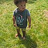 Zyair is registered to the contest to win money with this photo: afro_hair, backyard, barefoot, casual_clothing, child, concrete, daytime, fence, grass, nature, outdoor, person, shadow, shorts, standing, summer, sunlight, toddler, tshirt, young_child