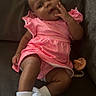 Sahara joined the competition — help win amazing prizes! baby, bow, child, couch, cute, face, footwear, hand, happy, indoors, infant, pacifier, pink_dress, portrait, relaxed, sitting, skin, smiling, white_socks, young_child
