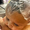 Sahara is registered to the contest to win money with this photo: arm, bathroom, blurred_background, casual, child, close_up, curious, expression, eye, face, head, human, indoor, person, portrait, resting, skin, skin_tone, wet_hair, young