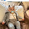 Prince joined the competition — help win amazing prizes! toddler, child, pacifier, sweatpants, hoodie, couch, pillow, blanket, indoor, casual_clothing, baby, sneakers, relaxed, home, person, portrait, seated, cute, young_child, face
