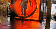 Declan is registered to the contest to win money with this photo: child, toddler, boy, smiling, standing, playground, indoor_playground, play_structure, climbing_frame, orange, mesh, tunnel, foam_floor, adidas_shirt, shorts, portrait, backlit, indoor, recreation, adventure