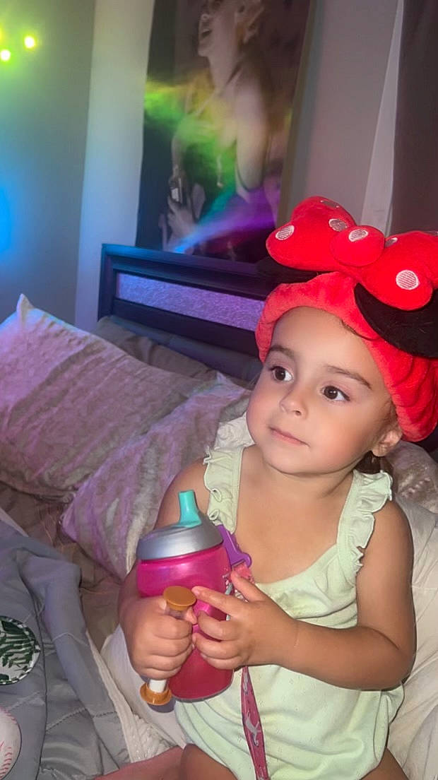 Rosalie is registered to the contest to win money with this photo: baby, baby_toddler_clothing, baseball_cap, cap, child, costume_hat, fashion_accessory, fun, happy, hat, headwear, lip, magenta, party_supply, person, picture_frame, pink, purple, skin, smile