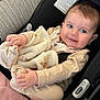 Wren is registered to the contest to win money with this photo: baby, infant, blanket, car_seat, blue_eyes, smiling, clothing, soft_texture, cute, child, indoors, seat_belt, comfort, toddler, portrait, hands, face, closeup, pink_blanket, warm