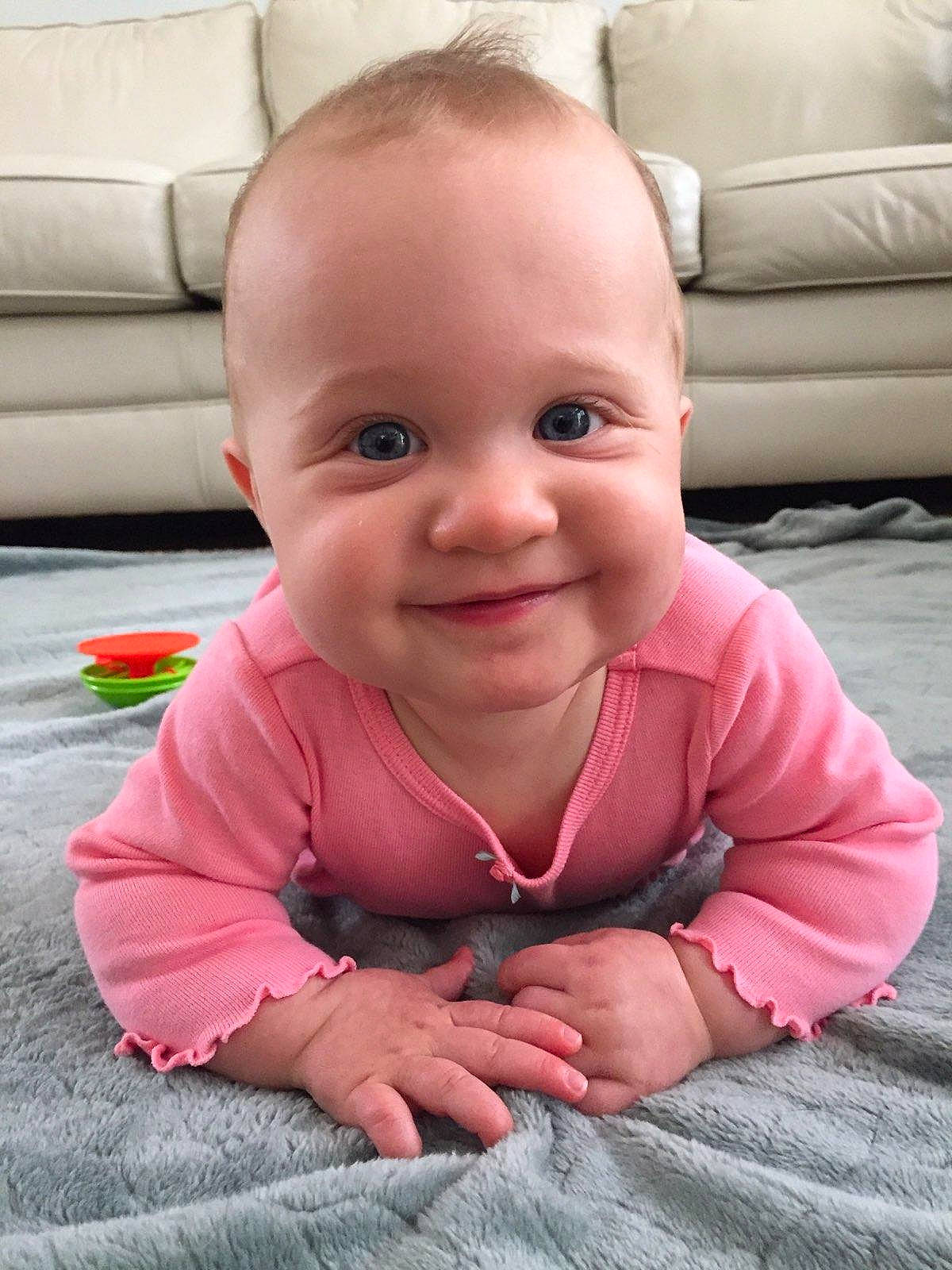 Brinley is registered to the contest to win money with this photo: baby, baby_toddler_clothing, cheek, child, chin, crawling, eye, face, facial_expression, forehead, head, joy, lip, mouth, nose, person, pink, sitting, skin, smile