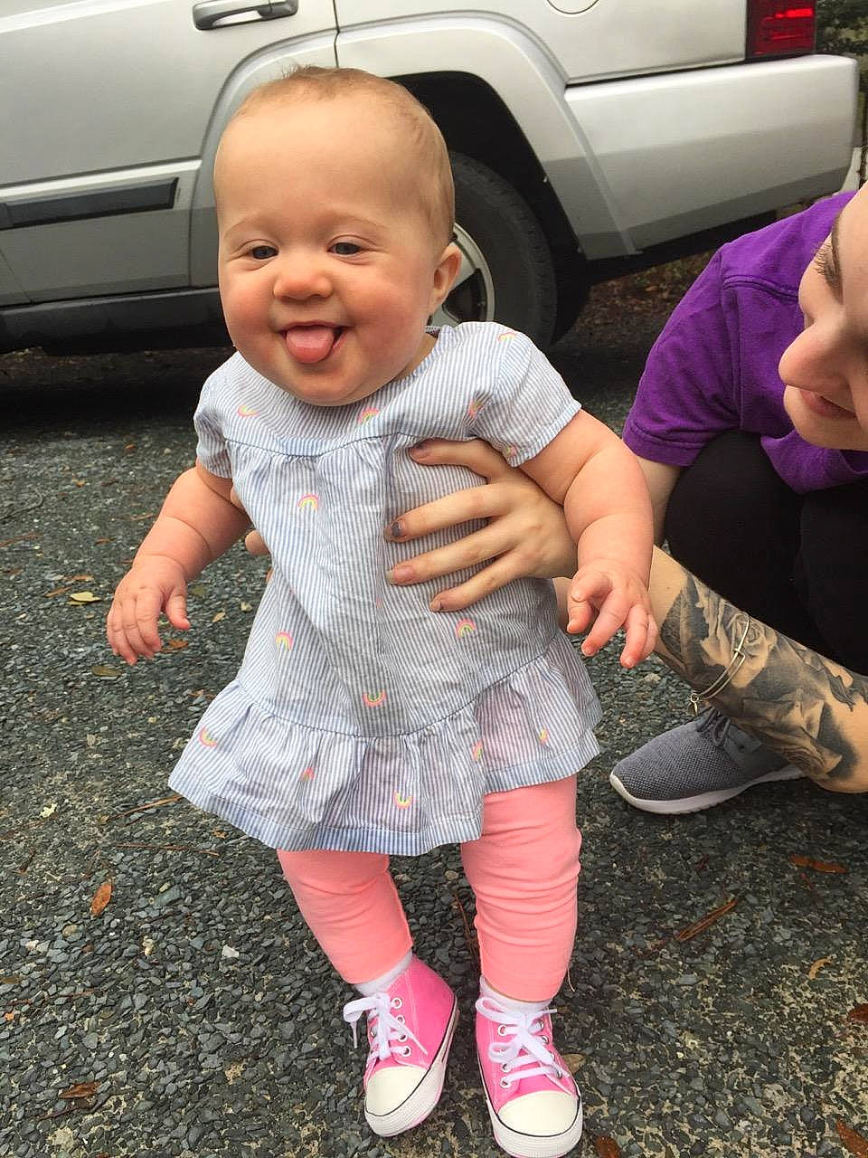 Brinley is registered to the contest to win money with this photo: baby, car, cheek, child, finger, footwear, fun, head, leg, people, person, pink, play, shoe, sitting, skin, smile, toddler, vacation