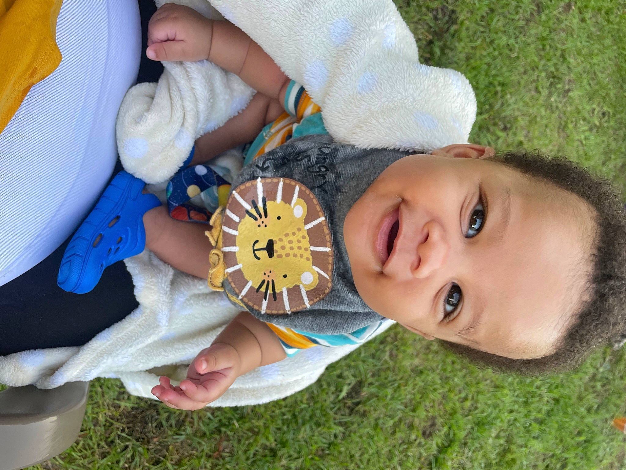 Izaiah is registered to the contest to win money with this photo: baby, baby_toddler_clothing, child, fun, grass, hand, happy, hat, human_body, leisure, mouth, nose, people_in_nature, person, plant, play, recreation, skin, smile, toddler