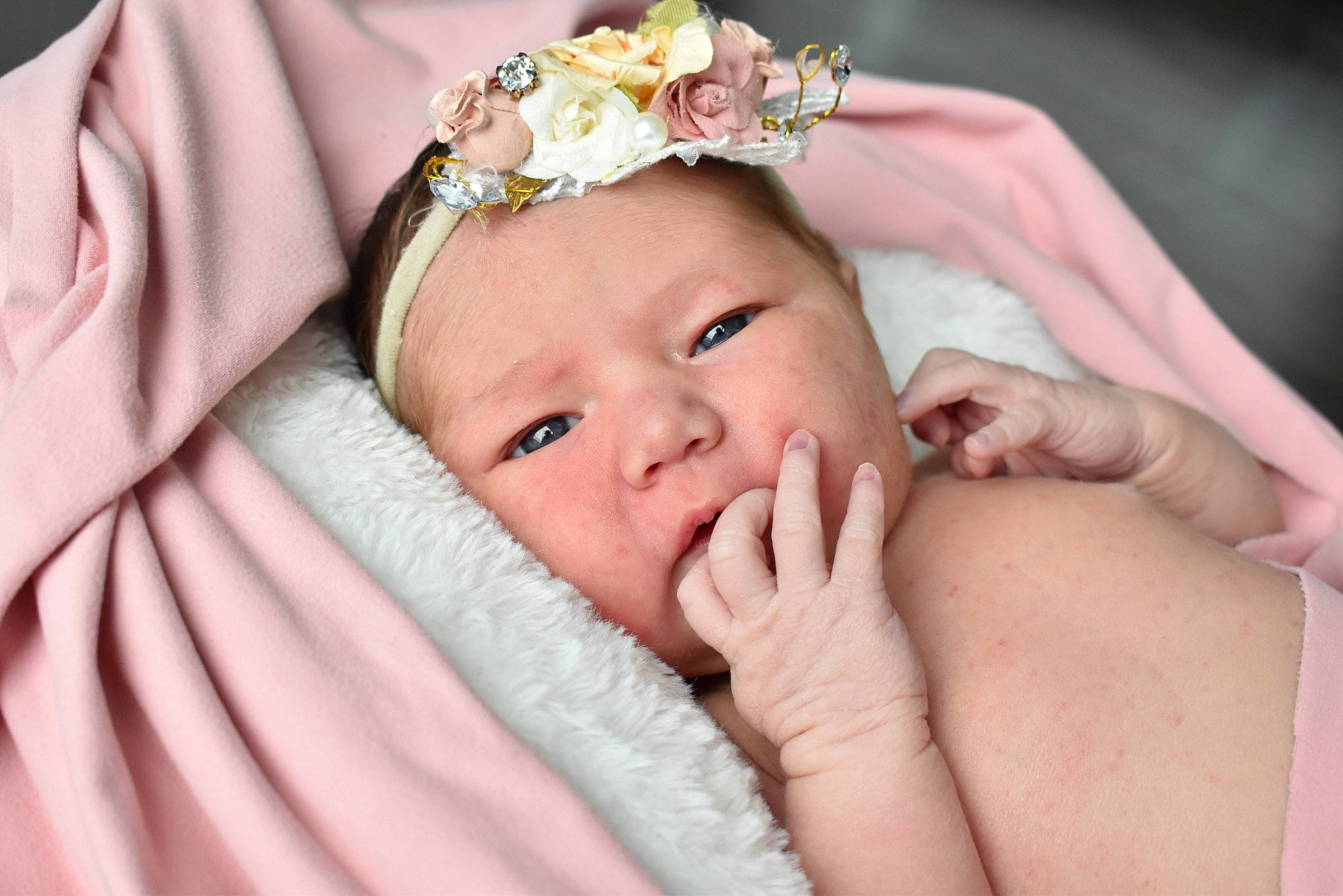 Haylee is registered to the contest to win money with this photo: baby, baby_toddler_clothing, child, comfort, dress, event, eyelash, finger, gesture, hair_accessory, hand, happy, headgear, headpiece, headwear, jewellery, nail, person, pink, skin