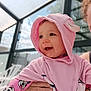 Victoria participe au concours pour gagner de l'argent avec cette photo : baby, building, cartoon_clothing, child, closeup, cute, daylight, eyelashes, face, glass, hand, happy, hood, outdoor, person, pink_towel, reflection, skin, smiling, window