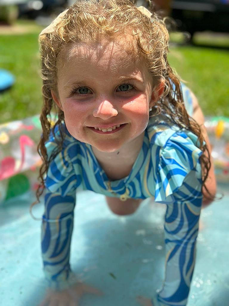 Lana is registered to the contest to win money with this photo: blond, child, city, electric_blue, fun, grass, hairstyle, happy, joy, laugh, leisure, outdoor_play_equipment, person, plant, portrait_photography, recreation, sitting, smile, soil, toddler