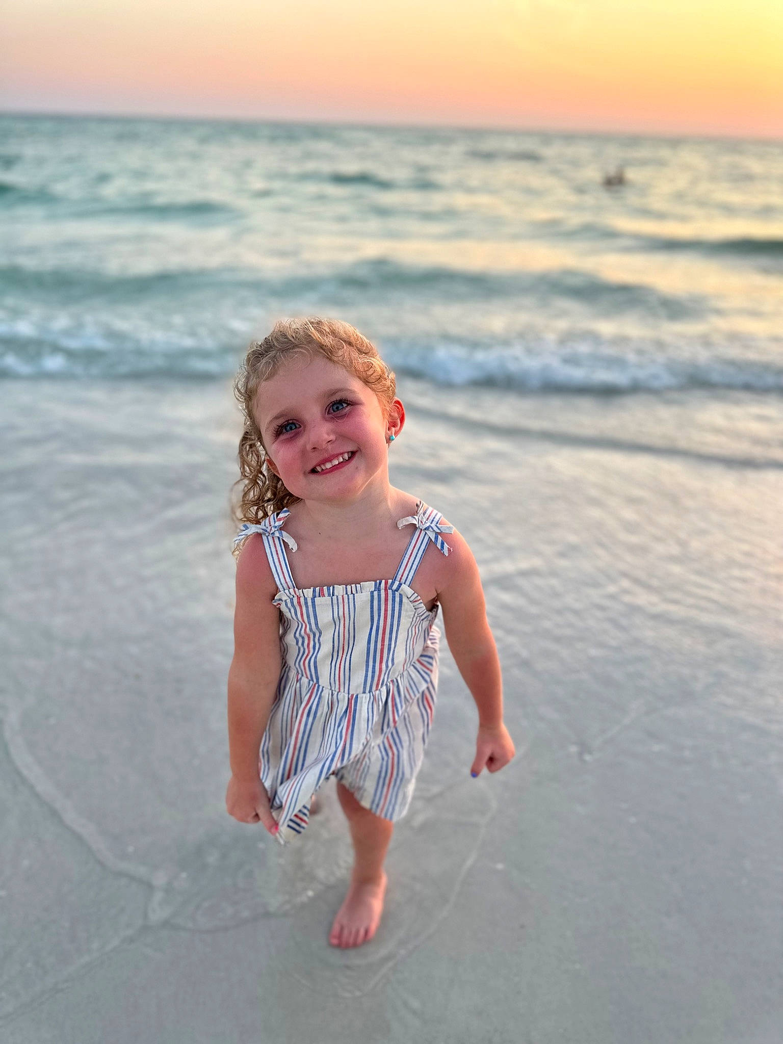 Lana is registered to the contest to win money with this photo: barefoot, beach, coast, coastal_and_oceanic_landforms, flash_photography, fun, happy, horizon, joy, landscape, leisure, people_in_nature, people_on_beach, person, shore, sky, smile, summer, sunlight, toddler