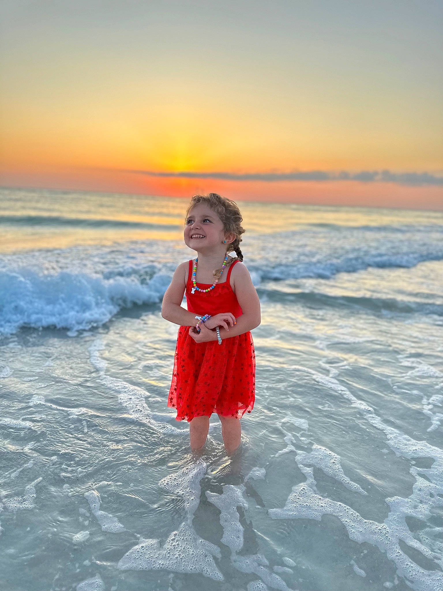 Lana is registered to the contest to win money with this photo: beach, cloud, dusk, flash_photography, fun, happy, horizon, joy, leisure, people_in_nature, people_on_beach, person, shore, sky, smile, standing, sunlight, sunrise, t_shirt, travel