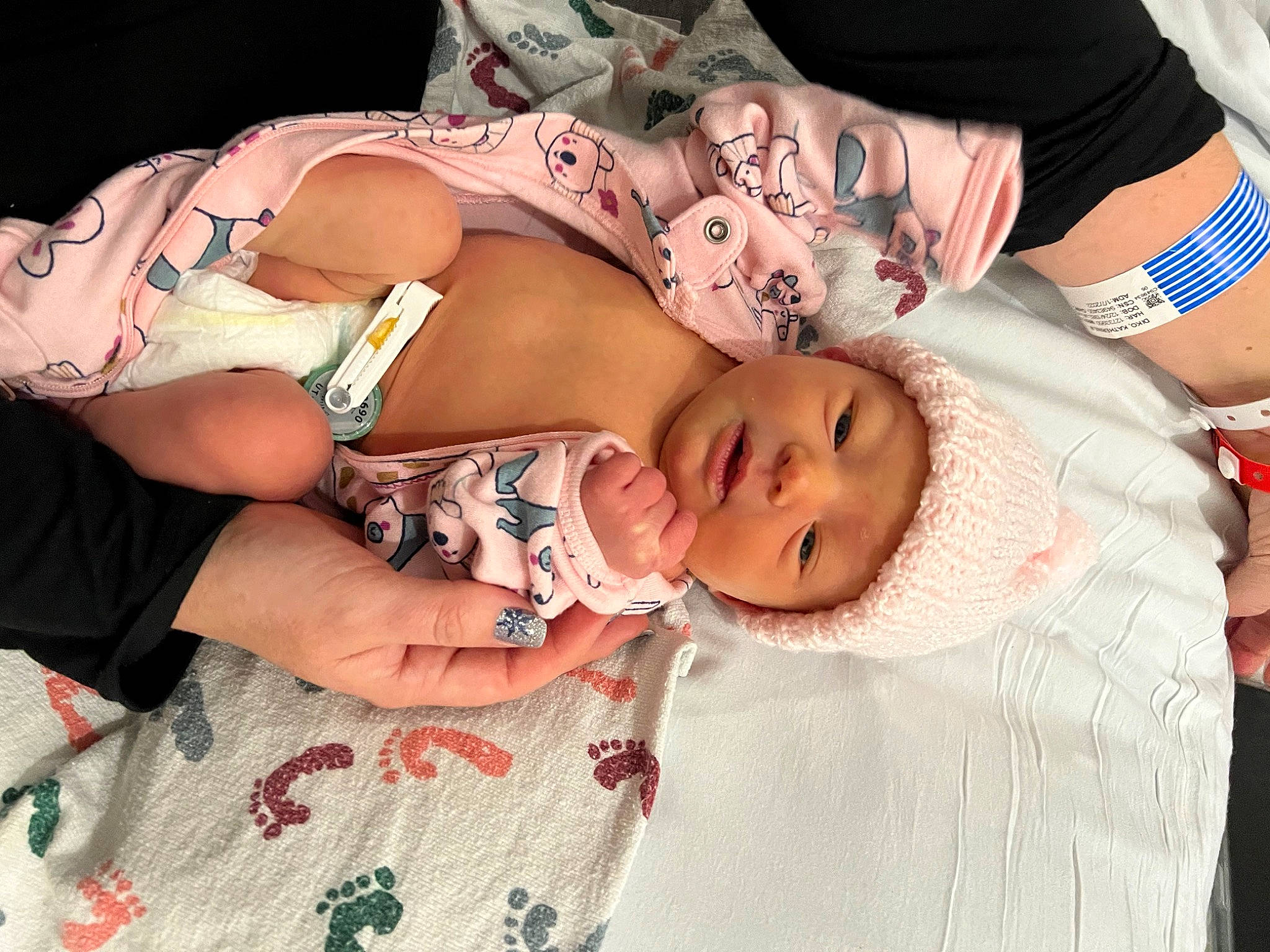 Jane is registered to the contest to win money with this photo: abdomen, baby, baby_products, baby_toddler_clothing, cheek, chest, child, finger, flesh, happy, hat, headwear, human_leg, nail, pattern, person, pink, skin, thigh, toddler