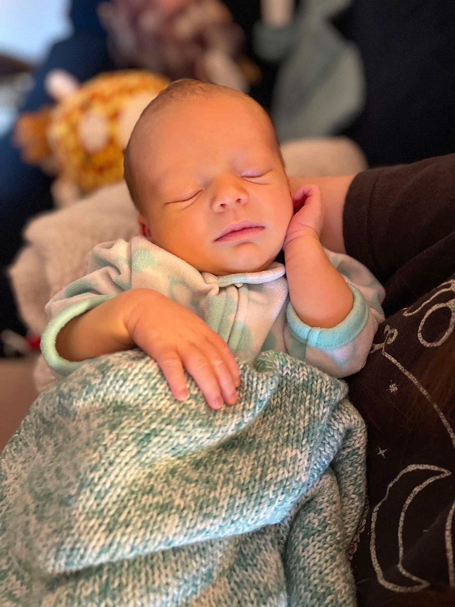 Jane is registered to the contest to win money with this photo: abdomen, baby, baby_toddler_clothing, cheek, child, comfort, finger, fur, gesture, happy, human, nail, person, sitting, skin, sleeve, thumb, toddler, wood, wool