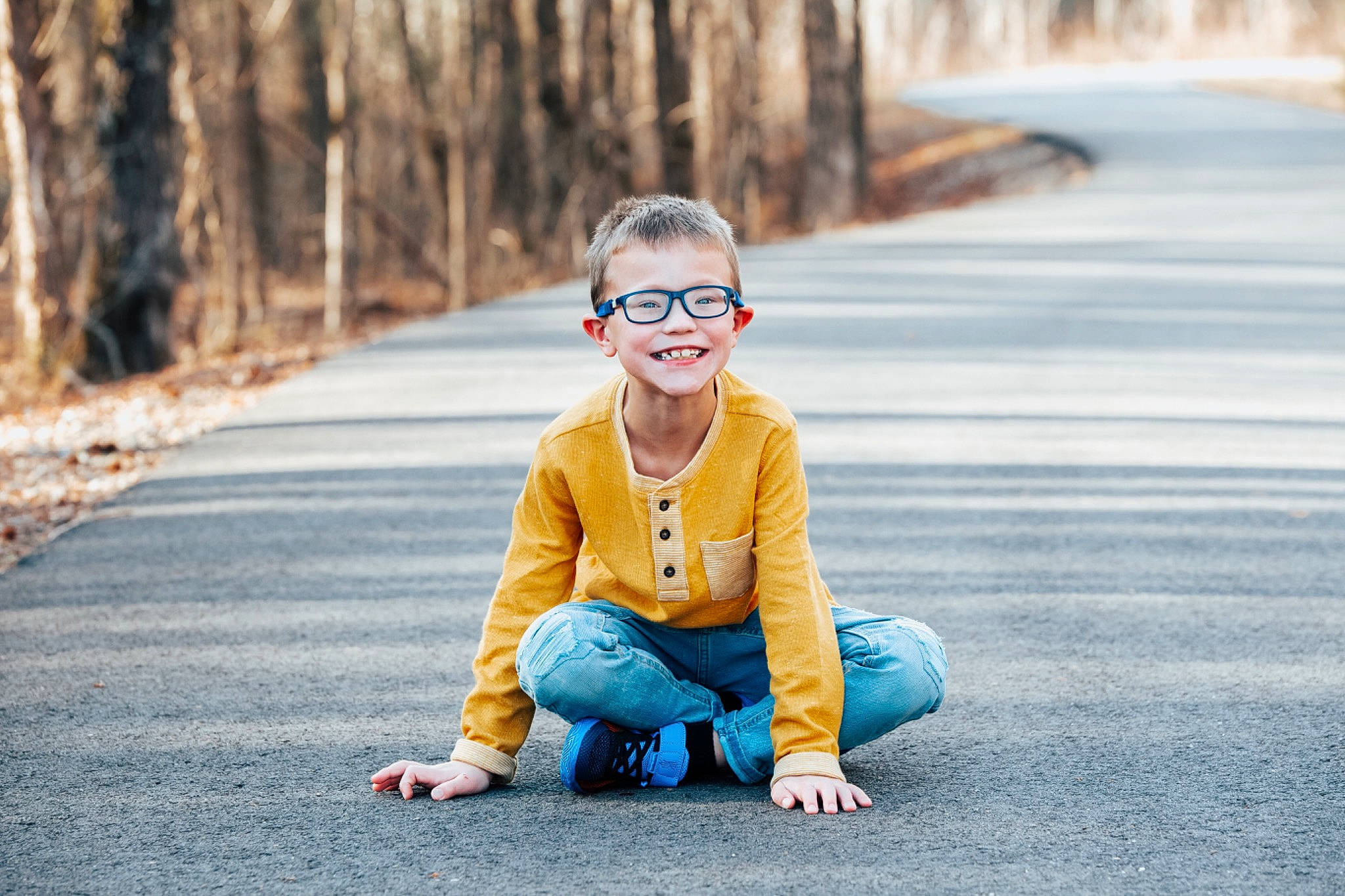 Matthew is registered to the contest to win money with this photo: asphalt, child, electric_blue, eyewear, fun, grass, happy, joy, leaf, leisure, people_in_nature, person, plant, recreation, road, road_surface, sitting, smile, spring, toddler
