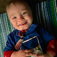 Andrew joined the competition — help win amazing prizes! baby, blanket, blue_shirt, child, closeup, clothing, cute, expression, face, hands, happy, indoor, person, portrait, red_sleeves, skin, smiling, striped, toddler, young_child