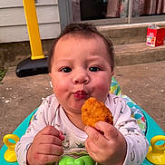 Mason joined the competition — help win amazing prizes! baby, child, food, chicken_nugget, walker, outdoor, concrete, basketball_hoop, toy, curious, face, hands, clothing, steps, window, curtain, background, expression, colorful, playful