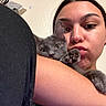 Bug is registered to the contest to win money with this photo: person, cat, face, paw, cuddle, indoor, skin, animal, pet, feline, cute, expression, portrait, young_adult, cozy, closeup, nose_piercing, eyebrows, fur, arm