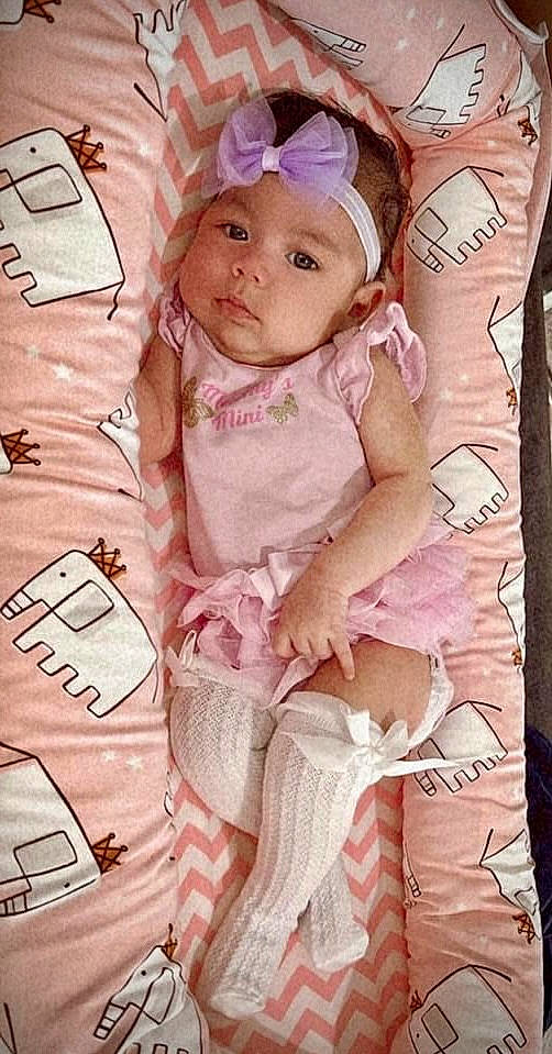 Faith is registered to the contest to win money with this photo: arm, baby, baby_products, baby_toddler_clothing, cheek, child, eye, eyelash, finger, hand, happy, head, headwear, linens, magenta, pattern, peach, person, pink, skin