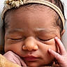 newborn, baby, sleeping, portrait, face, headband, flower, blanket, swaddled, peaceful, eyes_closed, infant, hands, indoors, closeup, soft_lighting, brown_hair, photography, cozy, adorable