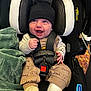 baby, smile, infant, car_seat, black_beanie, cast, blanket, winnie_the_pooh, pajamas, straps, harness, happy, child, seatbelt, footwear, indoors, person, cute, protection, toddler