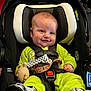Eris joined the competition — help win amazing prizes! baby, car_seat, child, smile, toy, bright_clothing, seat_belt, footwear, indoor, infant, happy, head_support, straps, safety, cute, chubby_cheeks, person, portrait, seat, holding