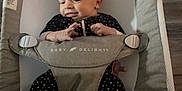 Kyra is registered to the contest to win money with this photo: baby, baby_delight, bouncer, child, comfort, cute, fabric, face, feet, hands, indoor, infant, newborn, onesie, person, relaxed, seat, smiling, star_pattern, wood_floor